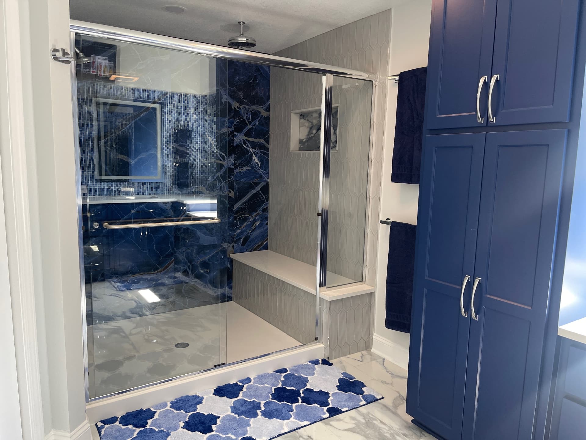 Blue stone slab primary bathroom remodel in Overland Park by Revived Spaces