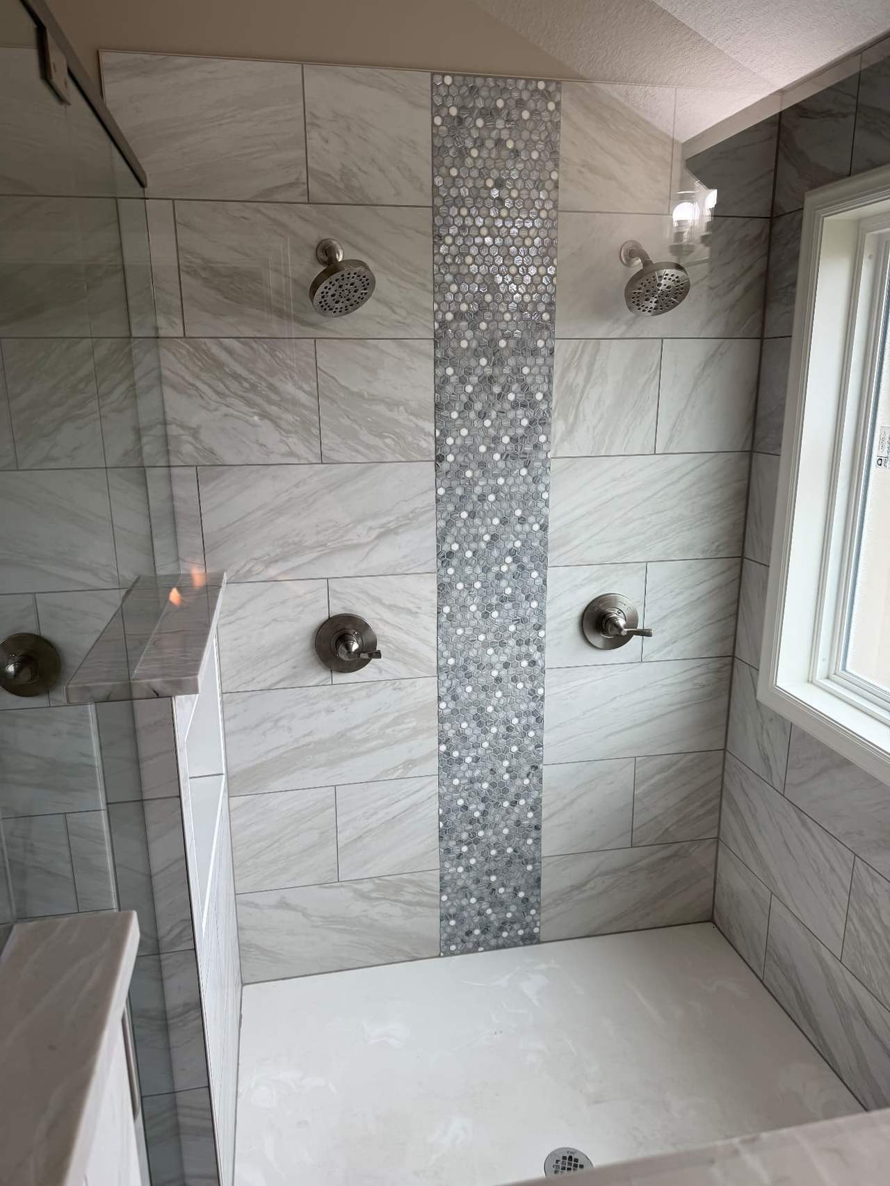 Luxury dual-head shower remodel by Revived Spaces