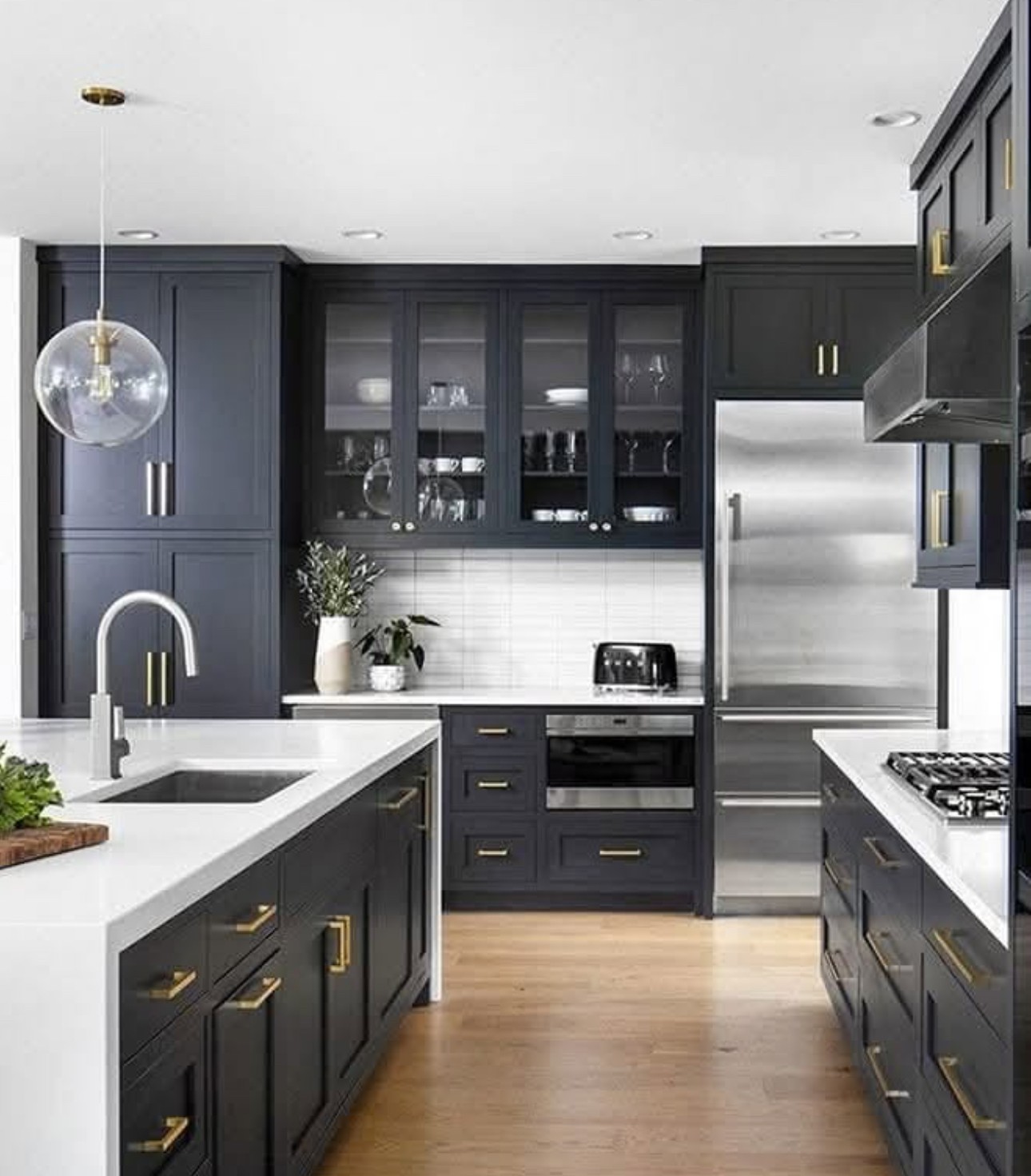 White cabinet kitchen with marble island remodeled by Revived Spaces in the Kansas City metro